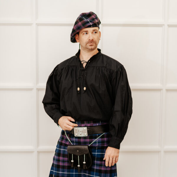A man in a Quality Wool Blend Kilt with Matching Tartan Flashes and FREE Kilt Hanger, showcasing a good and basic style while striking a pose for a photo.