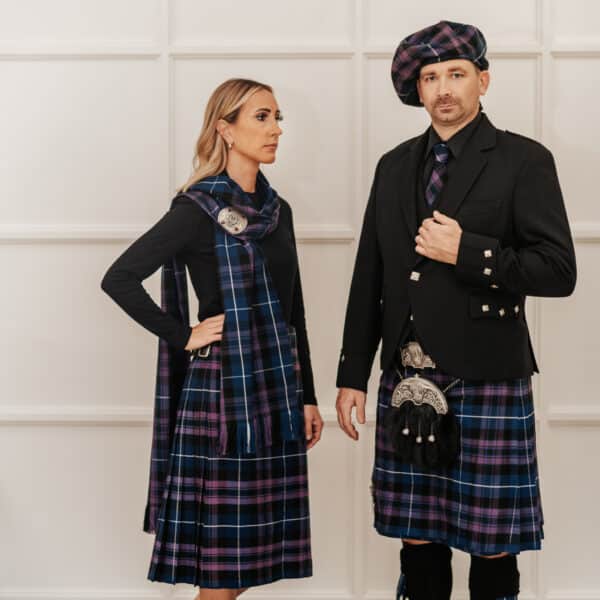A man and woman donning traditional Scottish kilts, complemented by Homespun Tartan Neck Ties.