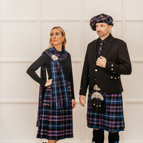 A man and woman in tartan clothing, wearing a Quality Wool Blend Kilt with Matching Tartan Flashes and FREE Kilt Hanger.