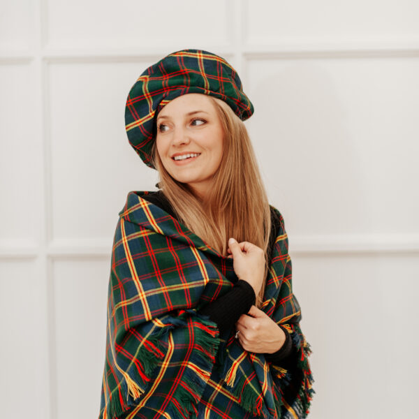 A young woman wearing a plaid hat and a Quality Wool Blend Kilt with Matching Tartan Flashes and FREE Kilt Hanger.