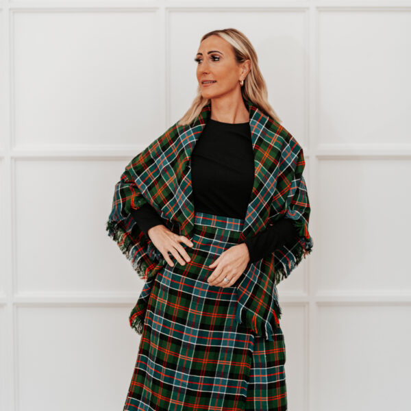 A woman in a Quality Wool Blend Kilt with Matching Tartan Flashes and FREE Kilt Hanger.