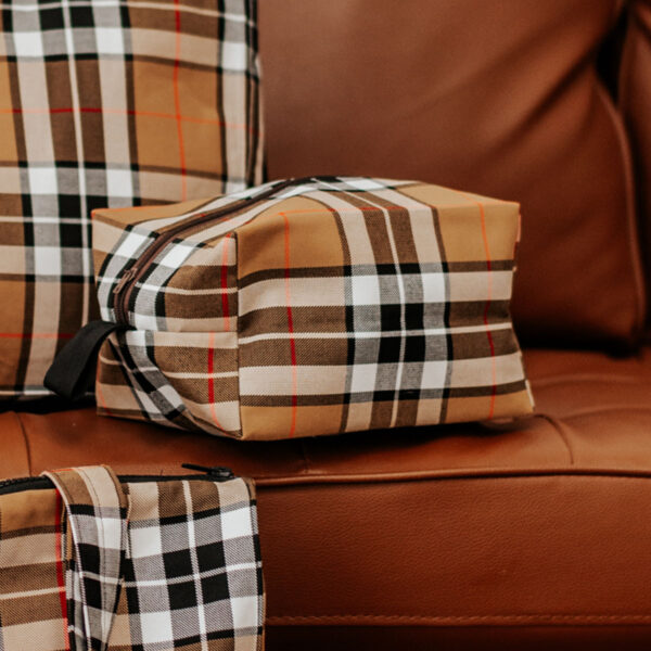 A group of Large Tartan Box Pouch - Poly/Viscose Wool Free on a couch.