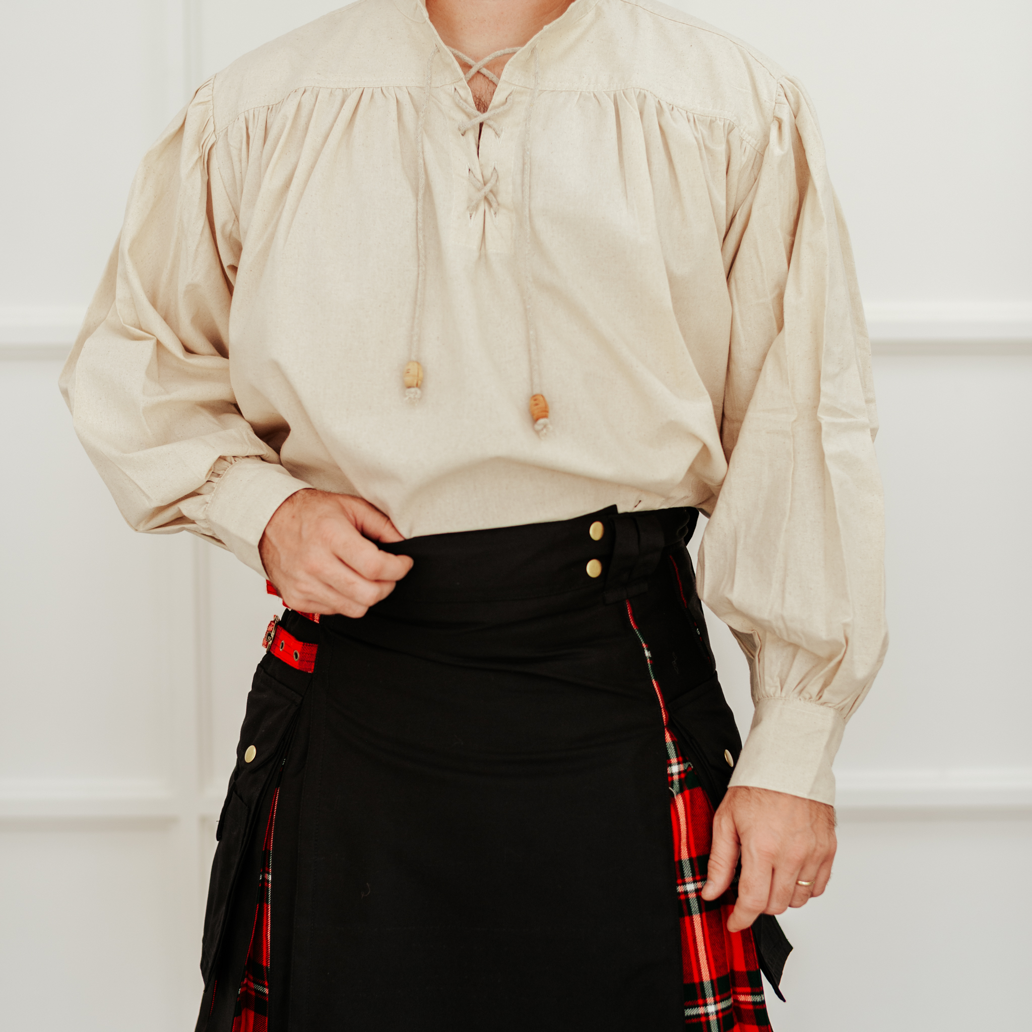 A man in a Hybrid Canvas and Tartan Utility Kilt - Bundle is posing for a photo.