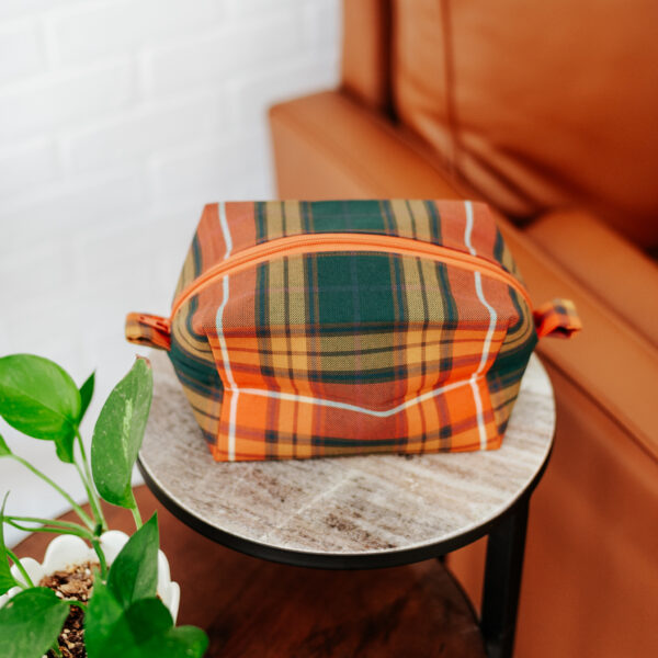 A Tartan Purse - Poly/Viscose Wool Free sitting on top of a coffee table.