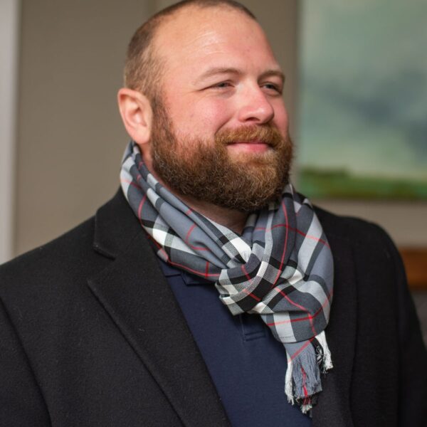 A man with a beard wearing a scarf.