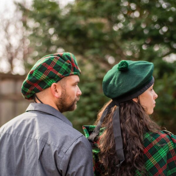 Description: A man and woman dressed in kilts, wearing Homespun Wool Blend Tartan Tams.