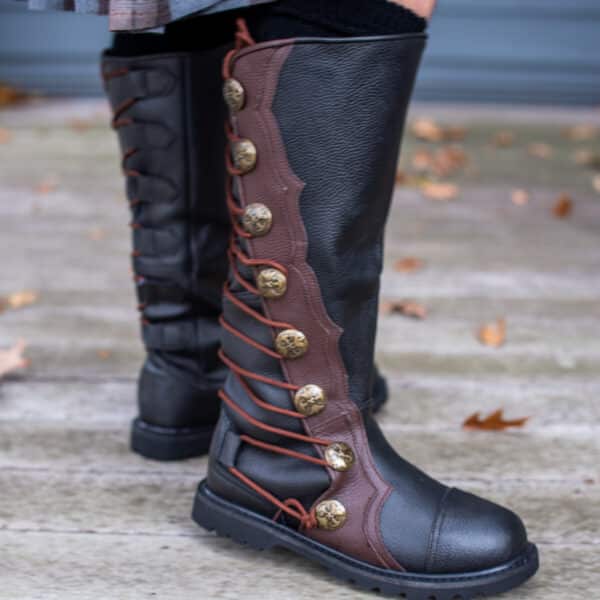 A girl wearing a pair of black and brown boots.