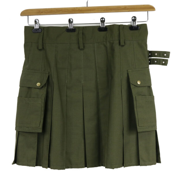 A green kilt with pockets hanging on a hanger.