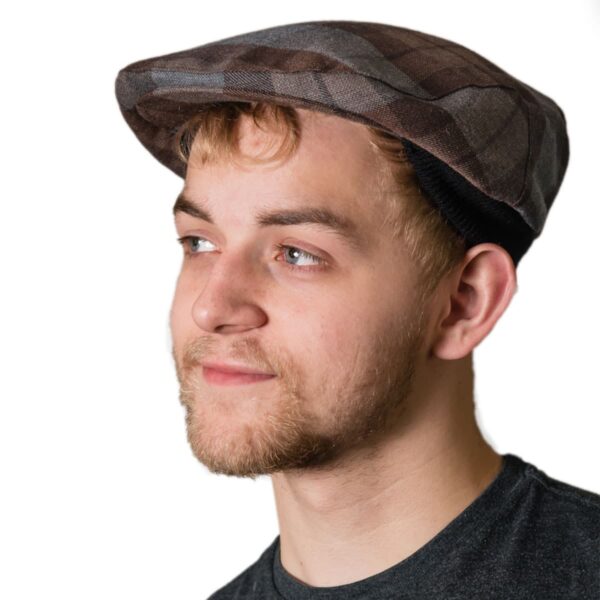 A young man wearing an OUTLANDER Golf Cap Authentic Premium Wool Tartan hat.