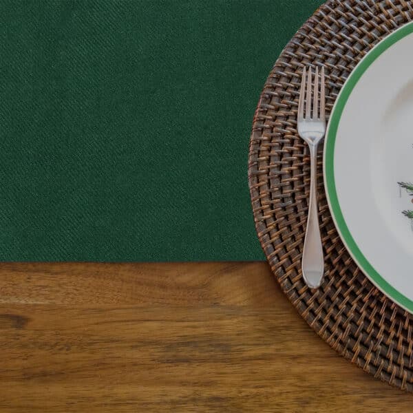 A plate with a fork and knife on a wooden table adorned with Reversible Tartan Placemats, specifically the Reversible Tartan Placemat - Wool Free.