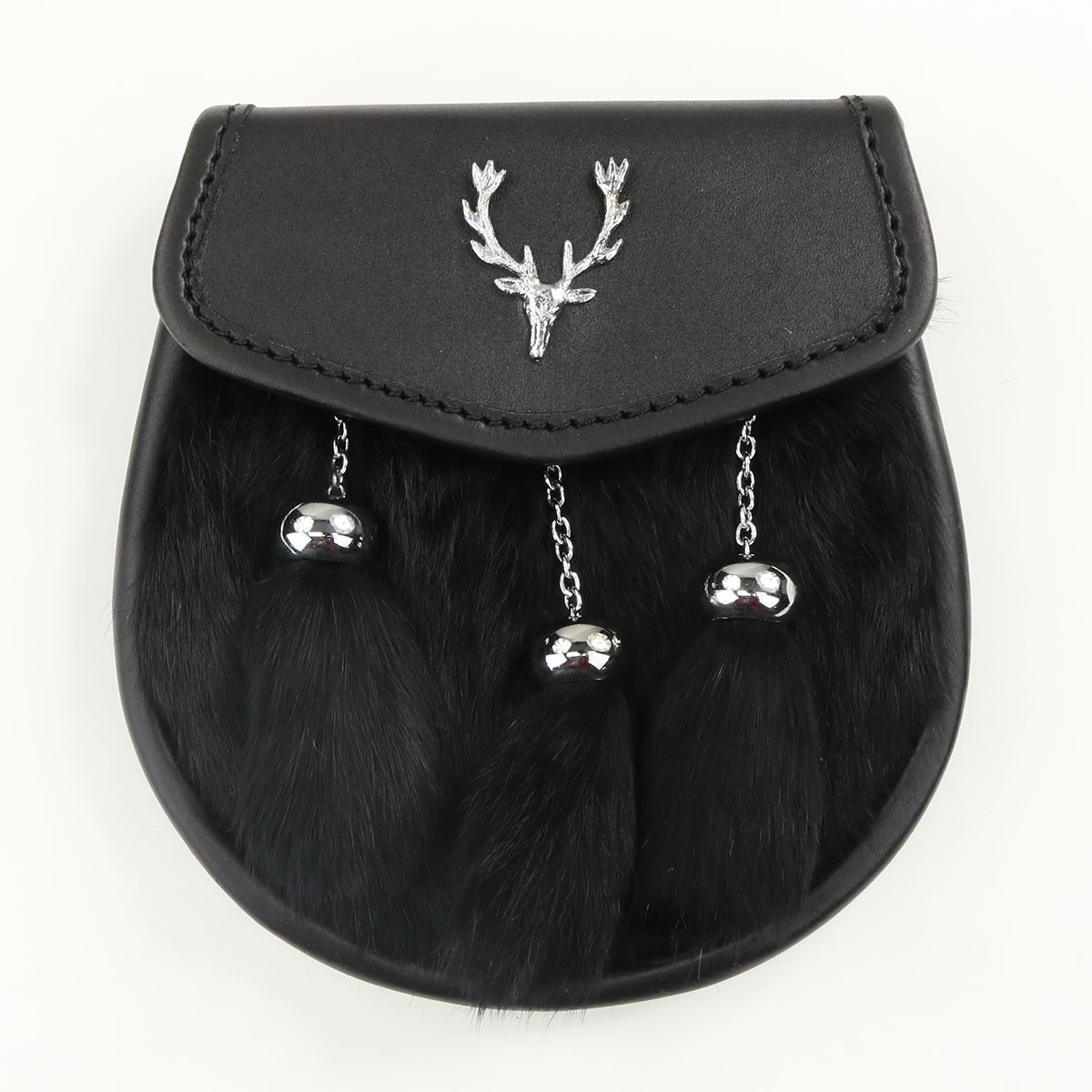 A black Scottish kilt with a Black Rabbit Fur Stag Sporran featuring two deer antlers hanging from it.