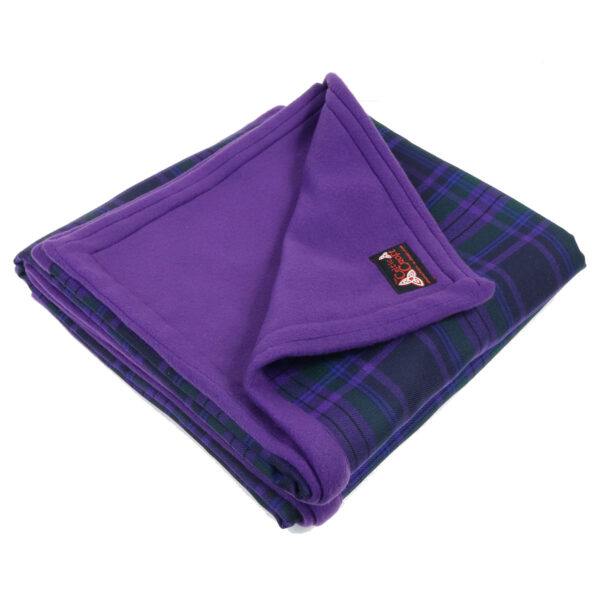 A purple plaid blanket with a Pictish Disc Triskelion Pin Brooch motif, folded on top of a white background.