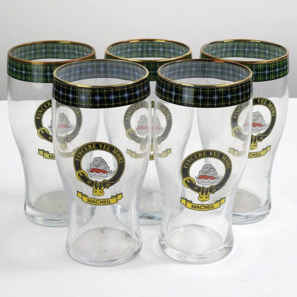 A set of four pint glasses with a crest on them.