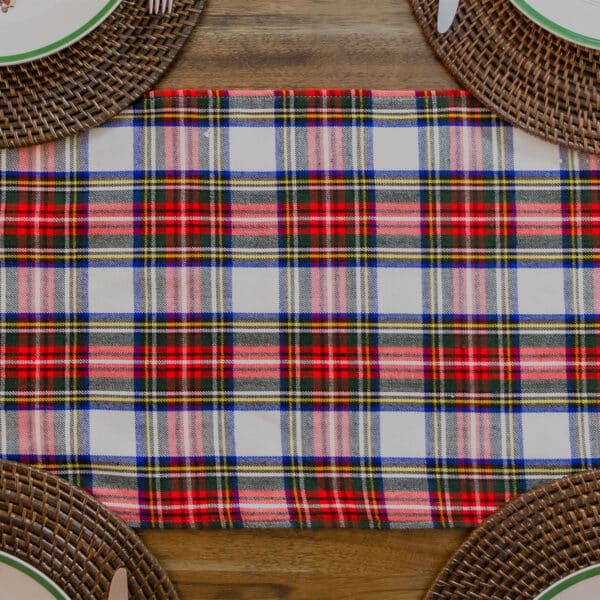 A Reversible Tartan Table Runner - Homespun Wool Blend on a wooden table.