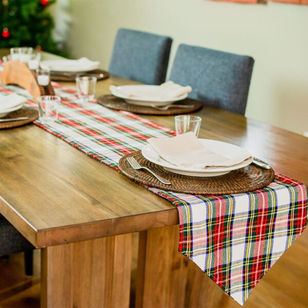 The Reversible Tartan Table Runner - Homespun Wool Blend adds a touch of homespun charm to a wooden table.