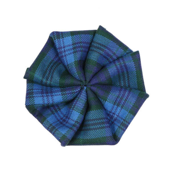 A blue and green Welsh Tartan Rosette - Medium Weight Premium Wool on a white surface.