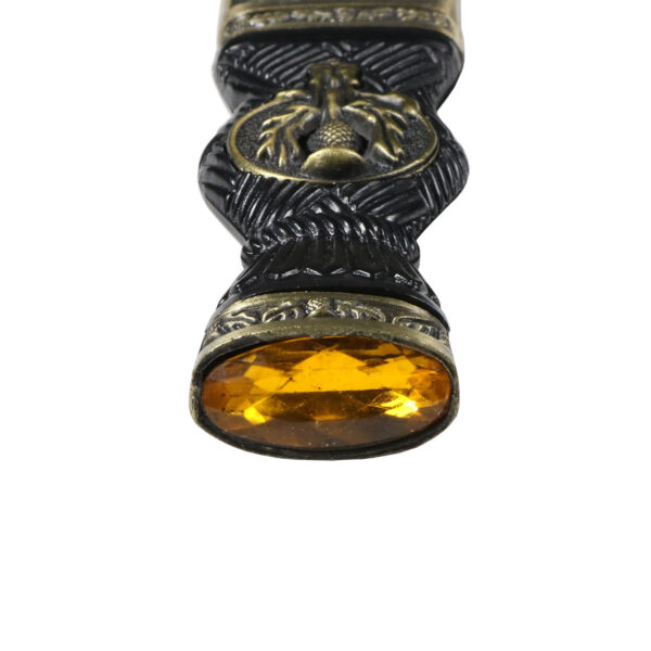 An ornate Thistle Sgian Dubh Bronze Finish Yellow Gem Top with a yellow stone.