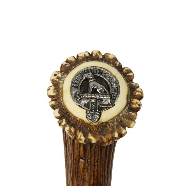 A Clan Crest Stag Handle Sgian Dubh with a clan crest badge on its stag handle.