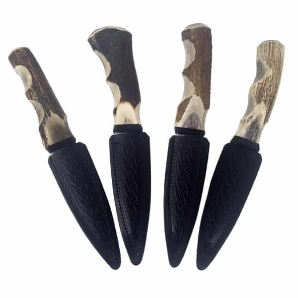 A set of Stag Handle Sgian Dubh knives with a black handle and a white handle. These knives are designed for versatility, with each one featuring either a stag handle or sgian dubh design.