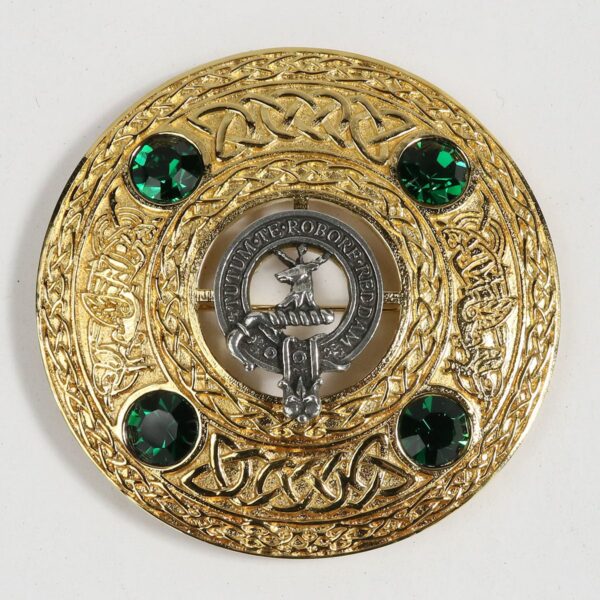 A gold and emerald claddagh brooch.
