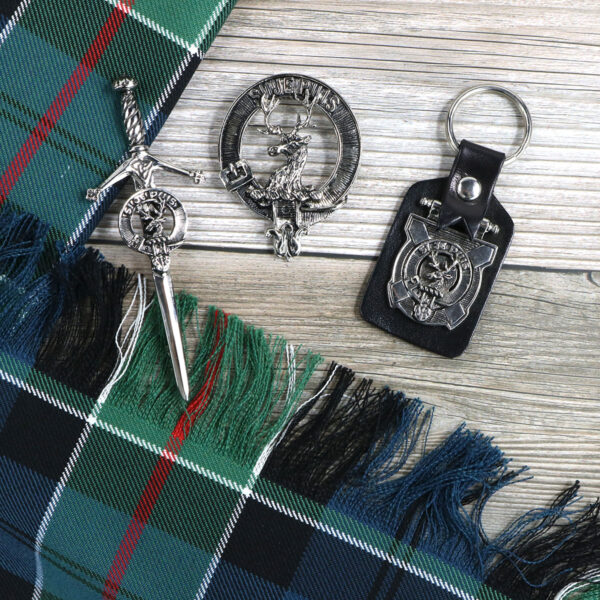 A scottish tartan keychain with a sword and a keyring.