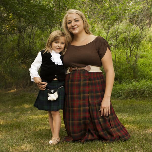 A woman and a little girl, both wearing Premium Wool-Free Kid Kilts, posing for a picture.