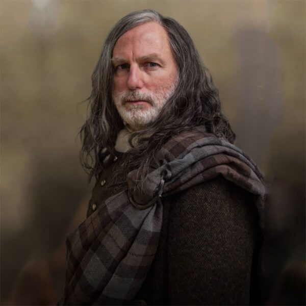 A man in a kilt with long hair and long beard.