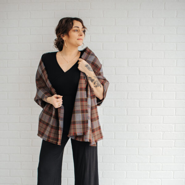 A woman wearing an OUTLANDER Stole Authentic Premium Wool Tartan jacket.