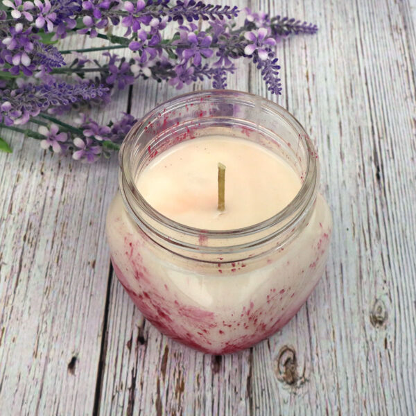 Homemade candles with lavender flowers in them.