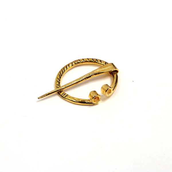 A Mini Penannular Brooch with a penannular ring on it.